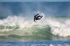 James Murphy takes flight in fun, rampy waves at Blackhead Beach, Dunedin, New Zealand.
