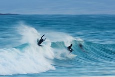 Elliott Brown shares a wave with a mate in fun, rampy waves at Blackhead Beach, Dunedin, New Zealand.