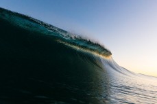 Last light illuminates a wave at Blackhead Beach, Dunedin, New Zealand.