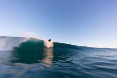 Brad Melville drops into a fun winter wave at Blackhead Beach, Dunedin, New Zealand.