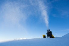 Snow guns fire on a bluebird day at Treble Cone Ski Resort, Wanaka, Central Otago, New Zealand.