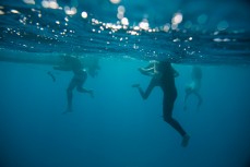 Swimmers after a testing day at Cloudbreak during the 2017 Fiji Launch Pad event held In the Mamanuca Islands, Fiji.