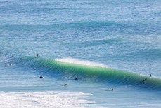 A set catches surfers out in fun waves on the north coast at Aramoana, Dunedin, New Zealand.