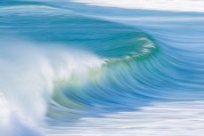 A wave peels into Shelley beach in a punchy swell near Aramoana, Dunedin, New Zealand.