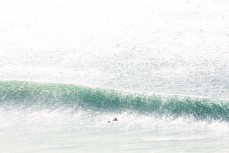A lone surfer lets a swell roll through during a punchy swell at Aramoana, Dunedin, New Zealand.