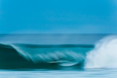 A surfer gets a barrel on dark at St Kilda, Dunedin, New Zealand.