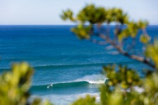 A couple of surfers share a peak in spring conditions near Smaills Beach, Dunedin, New Zealand.