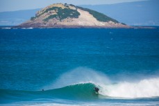 Justin Summerton finds a barrel in lazy spring waves at Blackhead Beach, Dunedin, New Zealand.