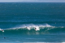 A surfer drops into a spring wave at Blackhead Beach, Dunedin, New Zealand.