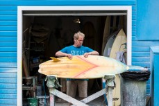Graham Carse checks out Justin Courtney's restoration Wayne Parkes at Quarry Beach Surfboards,  St Clair, Dunedin, New Zealand.