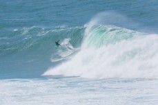 Nick Smart outruns a wave as a spring swell peaks at a remote reefbreak in the Catlins, Southland, New Zealand.