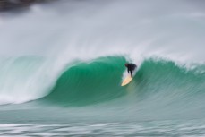 Jeff Patton drops in in solid conditions at a remote beach break in the Catlins, Otago, New Zealand.