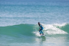 Rising grom Lewis Murphy making the most of glassy waves at St Kilda, Dunedin, New Zealand.