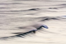 Spring winds airbrush a ground swell at Blackhead Beach, Dunedin, New Zealand.