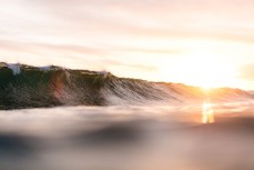 Sunset illuminates a summer ground swell at St KIlda, Dunedin, New Zealand.