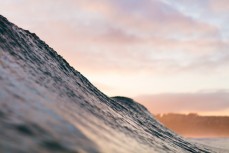 Sunset illuminates a summer ground swell at St KIlda, Dunedin, New Zealand.