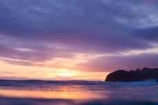 Sunset illuminates a summer ground swell at St KIlda, Dunedin, New Zealand.