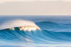 Late arvo light falls on fun waves at Blackhead Beach, Dunedin, New Zealand.