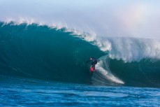 Dale Hunter revels in large surf conditions at a remote reefbreak near Dunedin, New Zealand.