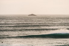 Surfers enjoy a summer east swell at St Kilda, Dunedin, New Zealand.