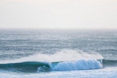 Surfers enjoy a summer east swell at St Kilda, Dunedin, New Zealand.