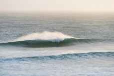 Surfers enjoy a summer east swell at St Kilda, Dunedin, New Zealand.