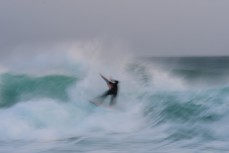 A surfer enjoys a summer east swell at St Kilda, Dunedin, New Zealand.