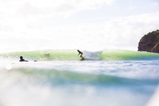 Odile Smits enjoys fun summer waves at Bethells Beach, Auckland, New Zealand.