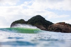 Fun summer waves at Bethells Beach, Auckland, New Zealand.