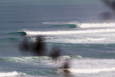 A surfer gets barrelled during a new swell a little bit raw at Raglan, Waikato, New Zealand.