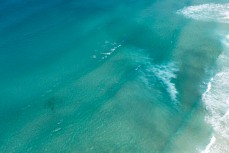 Aerial shots of the Dunedin coastline, lone surfer at Blackhead, Dunedin, New Zealand.