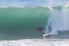 Jamie Civil hooks a bottom turn on a fast wave during a raw ground swell at St Kilda, Dunedin, New Zealand.