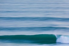 Clean, empty waves during a raw ground swell at St Kilda, Dunedin, New Zealand.