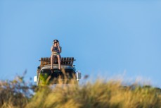 Crow's nest viewing as a raw ground swell sweeps into St Kilda, Dunedin, New Zealand.