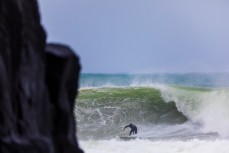 A surfer bottom turns on a large wave created by ex-cyclone Gita at Aramoana, Dunedin, New Zealand.