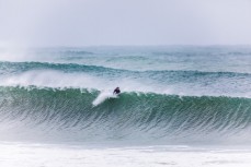 A surfer pulls back on a wave created by ex-cyclone Gita at Aramoana, Dunedin, New Zealand.