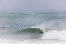Surfers make the most of waves created by ex-cyclone Gita at Aramoana, Dunedin, New Zealand.