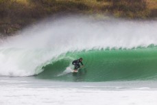 Joe Palmer makes the most of waves created by ex-cyclone Gita at Aramoana, Dunedin, New Zealand.