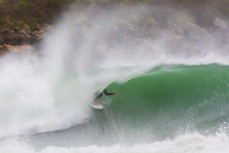 Brad Melville makes the most of waves created by ex-cyclone Gita at Aramoana, Dunedin, New Zealand.