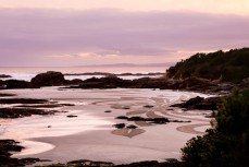 San Francisco artist Ian Ross creates an ephemeral piece of art from the low tide sand on the beach at Brighton, Dunedin, New Zealand. 