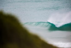 Surfers make the most of waves at a remote beach in the Catlins, Southland, New Zealand.