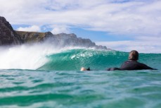 Surfers make the most of waves at a remote beach in the Catlins, Southland, New Zealand.