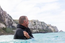 Surfers make the most of waves at a remote beach in the Catlins, Southland, New Zealand.