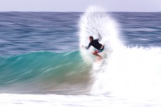 A surfer throws a fan of water at Snapper Rocks near Coolangatta on the Gold Coast, Queensland, Australia.