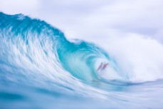 A surfer gets barreled at a Snapper Rocks near Coolangatta on the Gold Coast, Queensland, Australia.