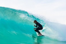 Kaya Horne throws the double shaka at Froggies near Coolangatta on the Gold Coast, Queensland, Australia.