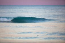 Only onew out in clean waves on a cold winter ground swell at St Kilda, Dunedin, New Zealand.