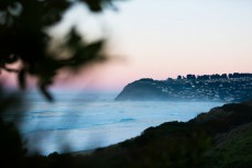 Dawn reveals small fun winter waves at St Kilda, Dunedin, New Zealand. 