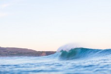 A peak breaks in fun wintry waves at St Kilda, Dunedin, New Zealand.