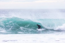 Artist Simon Kaan lining up a barrel in a small winter swell at St Clair, Dunedin, New Zealand. 